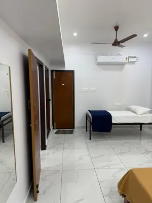 a hospital room with a bed and a door at Joseph's Residency Homestay in Podanūr