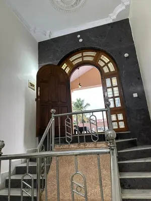a stairway with a large wooden door and a window at Raaha Luxury Home Stay in Mysore