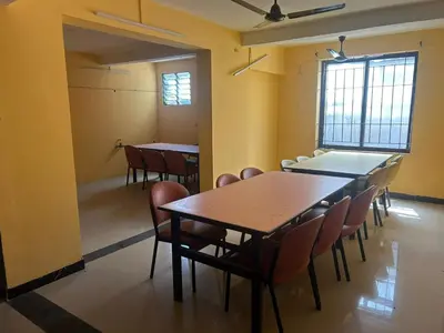 a classroom with tables and chairs in a room at Aishvarya Residency in Coimbatore
