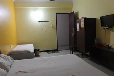 a hotel room with a bed and a basketball court at Aishvarya Residency in Coimbatore