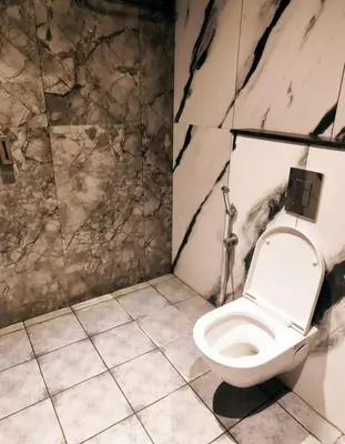 a bathroom with a white toilet in a room at Forest Soul by BOB Hotels - Forest Retreat with Pool in Batheri