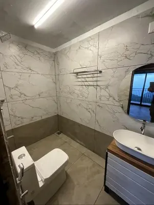 a bathroom with a toilet and a sink at Jalsa Bali, Kakkadampoyil, Calicut in Kakkadampoyil
