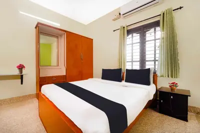 a bedroom with a large bed and a window at Collection O Singanallur Coimbatore in Coimbatore