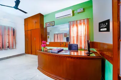 a reception desk in a room with a mirror at Collection O Singanallur Coimbatore in Coimbatore