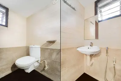 a bathroom with a toilet and a sink at Collection O Singanallur Coimbatore in Coimbatore