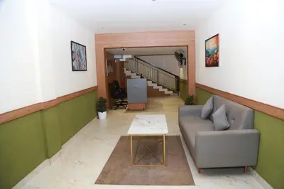 a living room with a couch and a table at Haaz Grande Kunnamangalam in Kunnamangalam