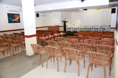 a row of chairs in a room with a church at Haaz Grande Kunnamangalam in Kunnamangalam