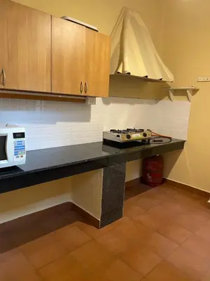 a kitchen with a counter top and a microwave at Glenwood in Coonoor