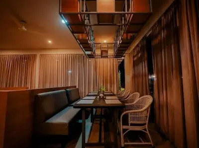 a restaurant with a table and chairs in a room at Whitelake Resort in Bilikere