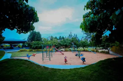 a playground with children playing in the sand at Whitelake Resort in Bilikere