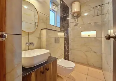 a bathroom with a sink and a toilet and a mirror at King Palace Ooty by VOYE HOMES in Ooty