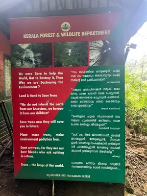 a sign for a medicinal forest and wildlife department at Enhance Lifestyle Service Apartments in Thamarassery