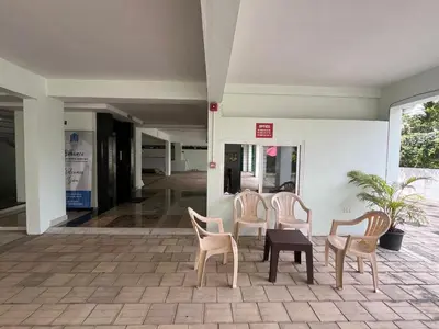 a group of chairs and a table in a building at Enhance Lifestyle Service Apartments in Thamarassery