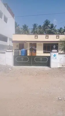 a building with a gate in front of it at GSC Family Cottage in Samattūr