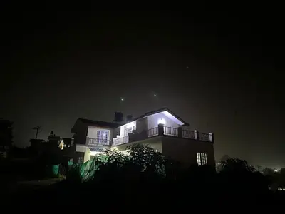 a house at night with its lights on at Sait's Westhill View Resort in Ooty
