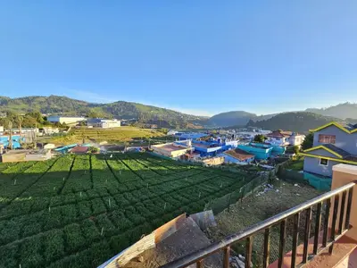 a view from the balcony of a small village at Sait's Westhill View Resort in Ooty