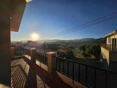 a balcony with a view of a city at Sait's Westhill View Resort in Ooty