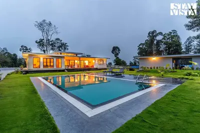 a house with a swimming pool in front of a house at Stayvista at Serenova with big pvt pool and lawn - Your Luxury escape awaits ! in Madikeri