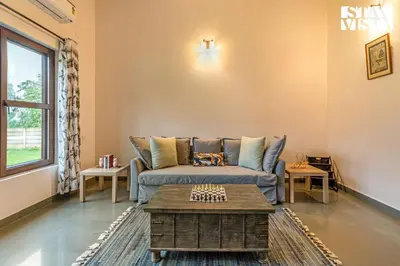 a living room with a couch and a coffee table at Stayvista at Serenova with big pvt pool and lawn - Your Luxury escape awaits ! in Madikeri
