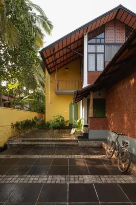 a house with a bike parked in front of it at Tranquil Nest in Kozhikode