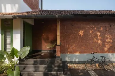 a bike parked on the side of a house at Tranquil Nest in Kozhikode
