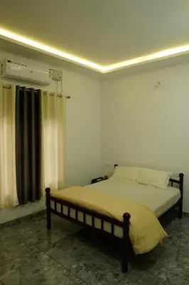 a bedroom with a bed in a room at Aroha Residence - Sleek and Spacious Wayanad Villa in Kalpetta