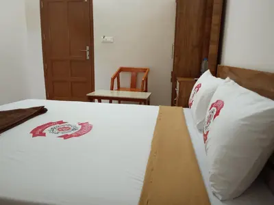 a bedroom with a bed with a box on it at Benzy Tourist Home in Ponnāni