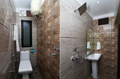 a bathroom with a toilet and a sink at Hotel O Chalakkudy River Annamanada Svasthya Retreat in Māla