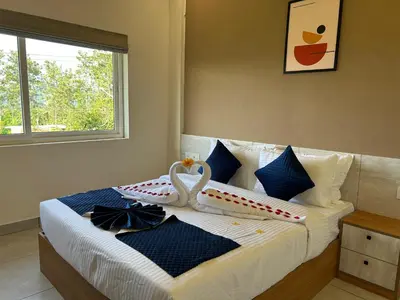 a bedroom with a bed with a swan decoration on it at Revoura Heights Apartments in Sultan Bathery