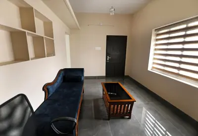 a living room with a couch and a table at Tranquil Rest House in Trichūr