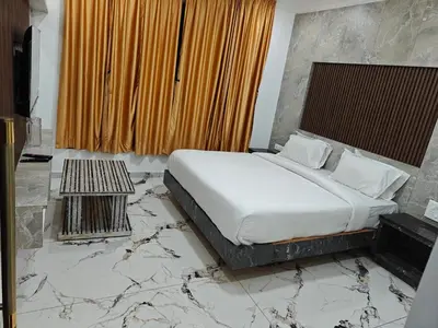 a bedroom with a bed with a marble floor at The Ooty Suites in Ooty