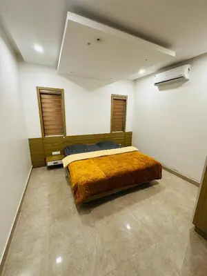 a bedroom with a bed with a brown blanket at Greenery Holiday Homes in Meppādi