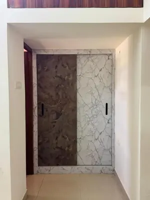 a door in a room with a stone wall at Marvee Luxus Stay in Coimbatore