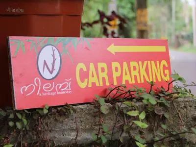 a red car parking sign on a wall at Nilambu Homestay in Nilambūr
