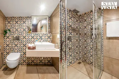 a bathroom with a toilet and a sink and a shower at The Fig Tree Villa by VEO - Part of StayVista in Madikeri