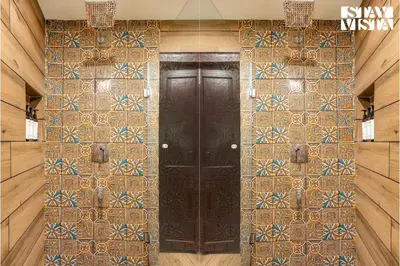 a door in a room with a tile wall at The Fig Tree Villa by VEO - Part of StayVista in Madikeri
