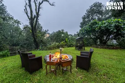 a table with food on it in the grass at The Fig Tree Villa by VEO - Part of StayVista in Madikeri