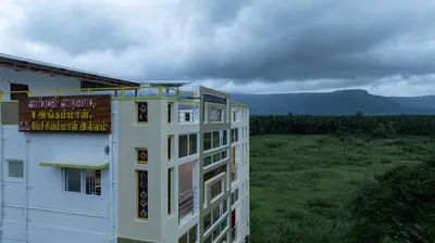 a building with a sign on the side of it at Sree Bharat Apartment in Coimbatore