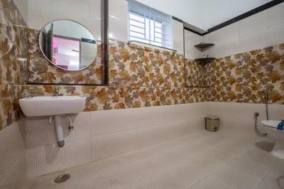 a bathroom with a sink and a mirror at Sree Bharat Apartment in Coimbatore