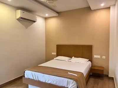 a bedroom with a bed and a air conditioner at FARIS ROOMs in Malappuram