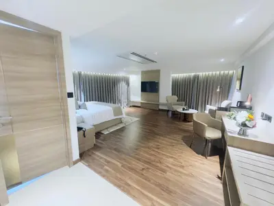 a hotel room with a bed and a bathroom at Oshin Calicut in Kozhikode