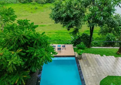 an overhead view of a swimming pool in a garden at Alaya Boutique Villa with Dam View by VOYE HOMES in Vythiri