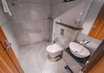 a small bathroom with a toilet and a sink at Alaya Boutique Villa with Dam View by VOYE HOMES in Vythiri
