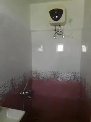 a bathroom with a toilet and a camera on the wall at Zirku Garden Kodaikanal in Kodaikānāl
