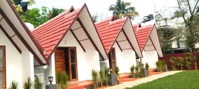 a house with a red roof at Dhruv Heritage Lake Resort Cherai in Cochin