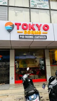 two motorcycles parked in front of a toyota dominods store at Tokyo Dorms in Kozhikode