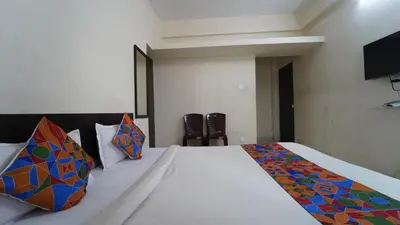 a bedroom with a large bed with colorful pillows at Honey Residency Codissia stay in Coimbatore