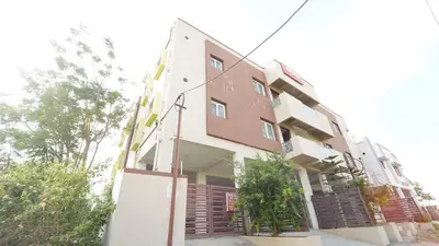 a tall building with wooden shutters on it at Honey Residency Codissia stay in Coimbatore