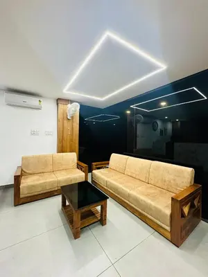 a living room with two couches and a table at Hotel Manal Suites in Green Island