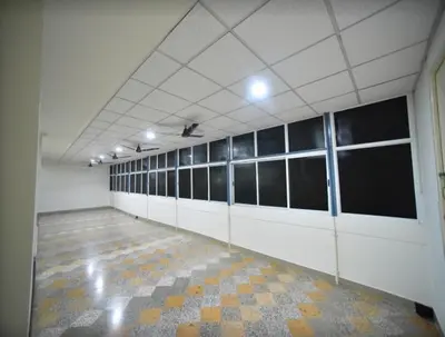 a large room with a row of stalls in a building at PRM Aruna Lodge in Erode